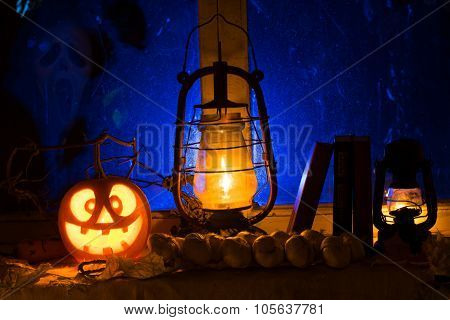 Photo Composition For Halloween From Mad Pumpkin, An Oil Lamp And Old Books