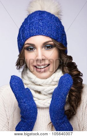Beautiful Girl With Gentle Makeup, Curls And Smile In Blue Knit Hat. Warm Winter Image. Beauty Face.