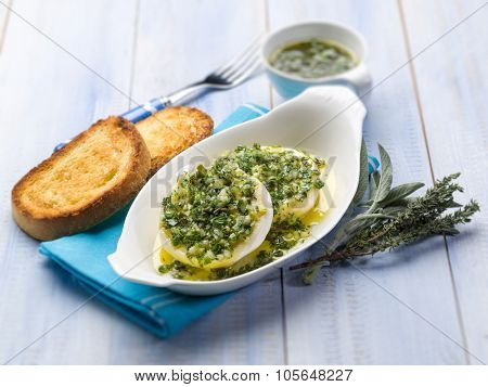 marinated tomino cheese with herbs, selective focus
