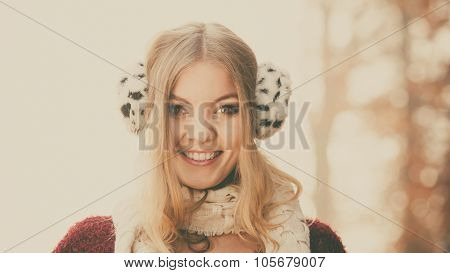 Portrait Of Pretty Smiling Woman In Fur Earmuffs.