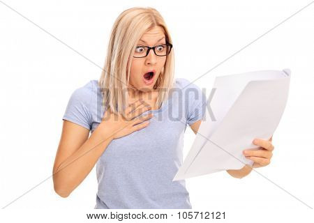 Baffled young woman looking at a piece of paper in disbelief isolated on white background