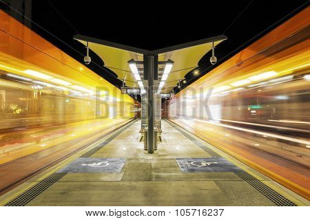 G: Link Trams zooming past the station