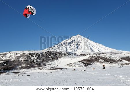 Snowkiting: Sportsman Glides On Skis On Background Volcano