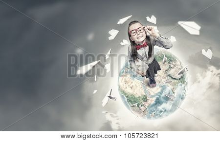 Wideangle picture of funny schoolgirl with paper plane. Elements of this image are furnished by NASA