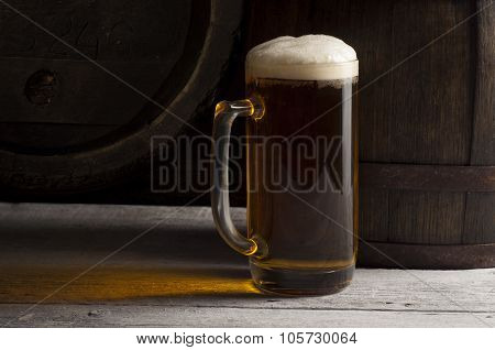 Still Life with a keg of beer and draft beer by the glass.