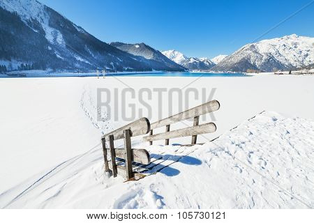Wooden stairs covered with snow