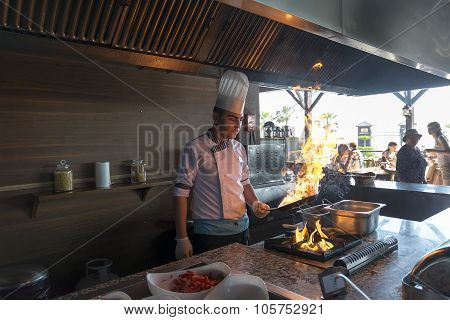 ISTANBUL TURKEY SEPT 28 2014 Chef in restaurant kitchen doing flambe on food