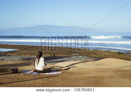 Young Girl Meditates Sitting