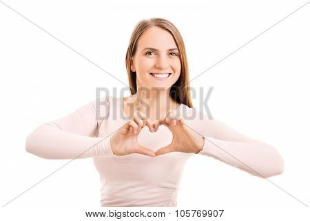 Beauty portrait of a smiling young girl making a heart shaped hand gesture, isolated on white background.
** Note: Visible grain at 100%, best at smaller sizes