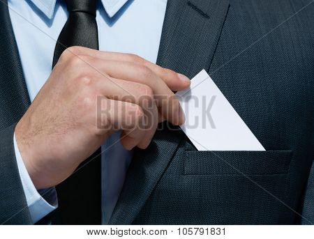 Close up of business man hand who takes out business card from the pocket of business suit