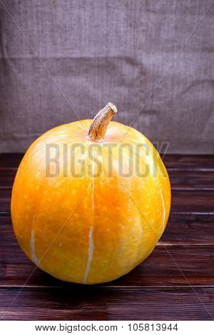 One Pumpkin On A Wooden Table