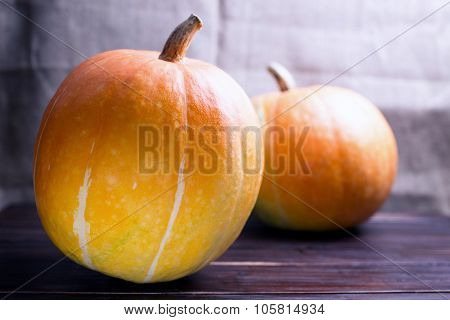 Two Big Pumpkins On A Table