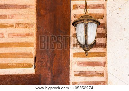 Lamp Hanging On A Brick Wall