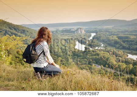 Young girl over castle under river and wonderful landscape