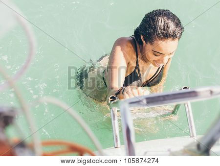 Beautiful Girl Getting On The Boat After Swim