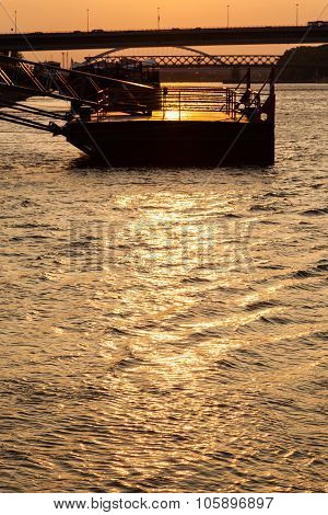 Bridge And Jetty On Danube River At Yellow Dawn
