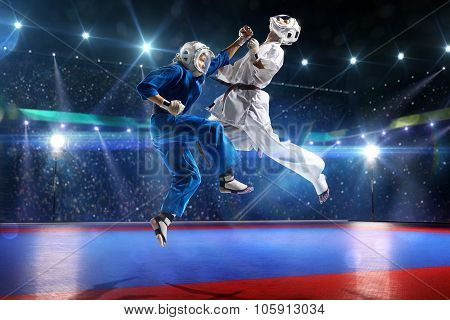 Two kudo fighters are fighting on the grand arena