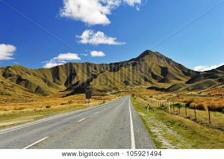 Road in Lindis Pass beautifully lit by the evening sun. Otago region, New Zealand