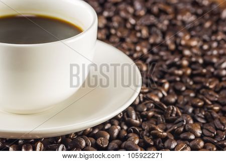 A Cup Of Coffee And Coffee Beans Background, Warm Toning, Selective Focus