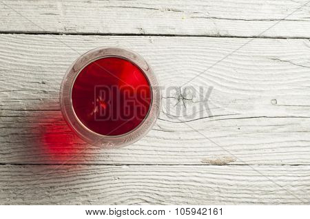 Glass white wine and bunch grapes on background of wooden