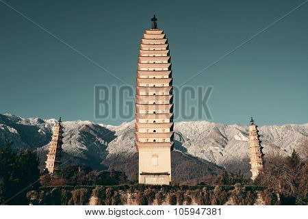 Ancient pagoda in Dali old town with snow capped Mt Cangshan, Yunnan, China.