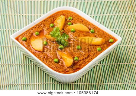 indian potato curry isolated on green mat