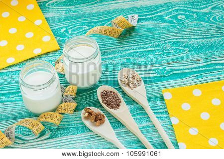 yogurt with measuring tape wooden spoons