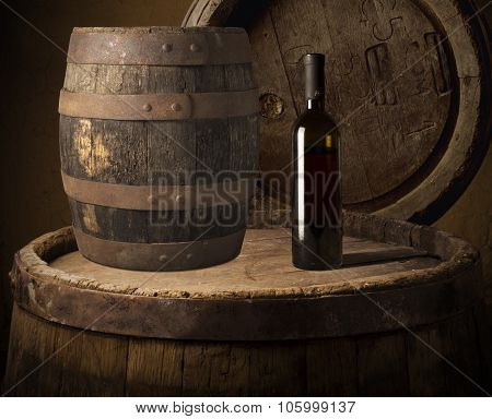 Still life with wine bottles, glasses and oak barrels  vintage