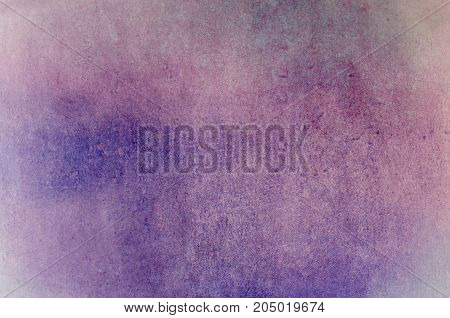 Background combining a rough patchy grunge texture with raindrops in merging pinks and purples