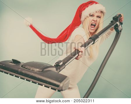 Angry Girl In Santa Helper Hat With Vacuum Cleaner