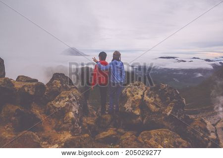 Couple standing on top of Mount Sibayak, Indonesia