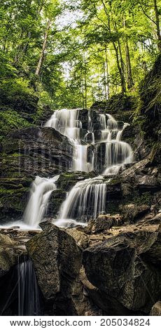 Forest river cascade waterfall. Shepot falls Carpathians