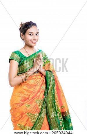 Happy young beautiful traditional Indian woman in traditional saree, Welcome Posing