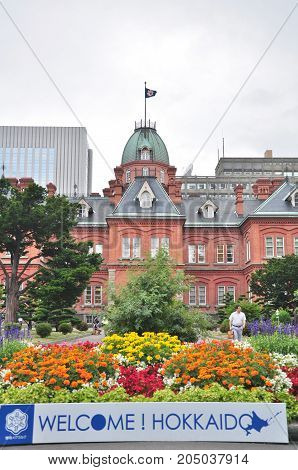 Hokkaido, Japan - July 24, 2013: The Former Hokkaido Government Office with a welcome sign in Sapporo city, Hokkaido, Japan. That Building was first completed in 1888 and known in Red Bricks Building.