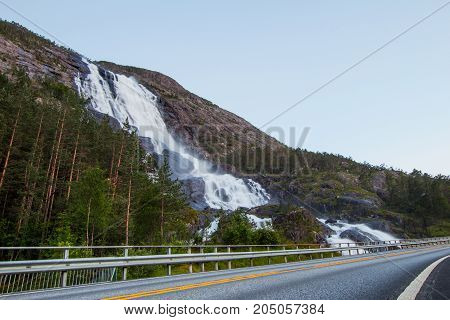 Summer Mountain Langfossen Waterfall On Slope Etne, Norway.