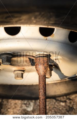 Mechanic fixing changing and repair old car tire with rim socket wrench