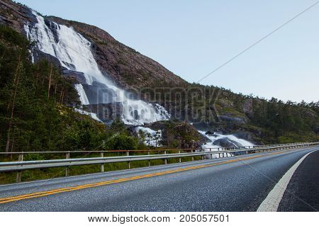 Summer Mountain Langfossen Waterfall On Slope Etne, Norway.
