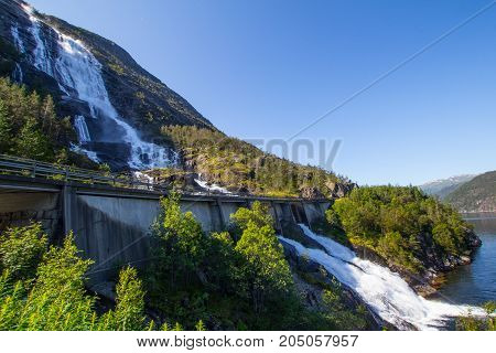 Summer Mountain Langfossen Waterfall On Slope Etne, Norway.