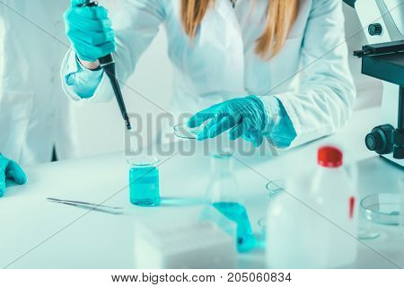 Laboratory Technician With Micro Pipette, Toned Image, Two Women