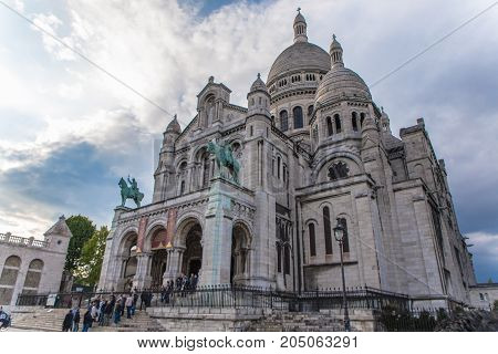 PARIS FRANCE - 28 APRIL 2017: tourists walking near Sacre Coeur Basilica entrance also known as Basilica of Sacred Heart. Situated in Montmartre which is the highest 130 meters hill in Paris