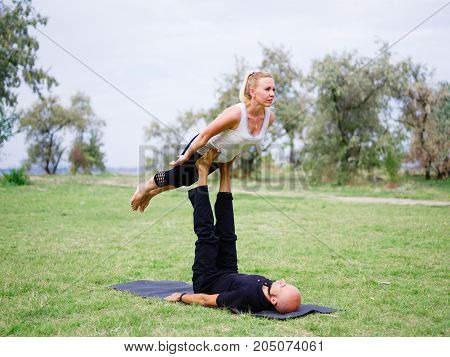 Photo of practicing yoga outdoor. Doing yoga fitness. Exercise for relax and healthy body.