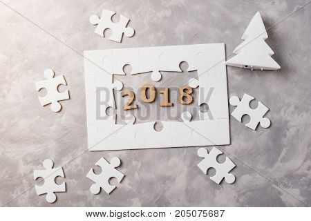 New Year Concept 2018. Jigsaw Puzzle On Grey Concrete Background.