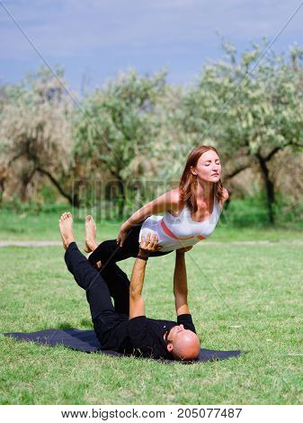 Photo of practicing yoga outdoor. Doing yoga fitness. Exercise for relax and healthy body.