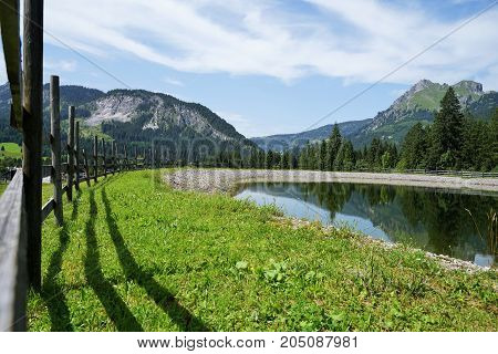 Wooden fence in the Alps under blue sky