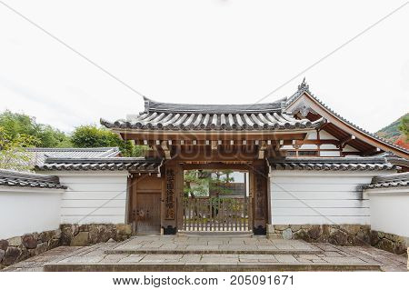 KYOTO JAPAN - NOVEMBER 23 2016 Tenryu-ji Temple North Gate sprawling Zen temple with one of the finest gardens in Kyoto and wonderful mountain views. Hiker looking temple in trip in Arashiyama Tokyo Japan country.