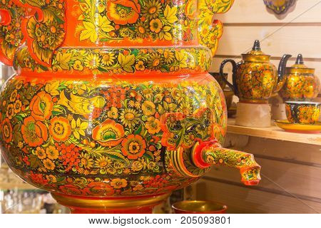 Russian Souvenirs. Samovar in the shop window in St. Petersburg Traditional Russian samovar. Tea samovar. Wooden house.