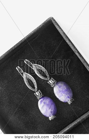 Amethyst vintage earrings with diamonds in black jewel box closeup