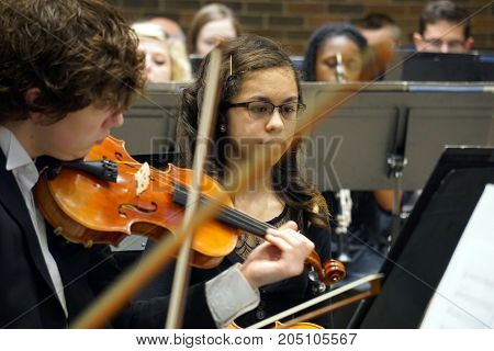 ROMEOVILLE, ILLINOIS / UNITED STATES - MAY 21, 2017: Violinists of the Metropolitan Youth Symphony Orchestra (MYSO) perform music in a concert in Borromeo Hall at Lewis University.