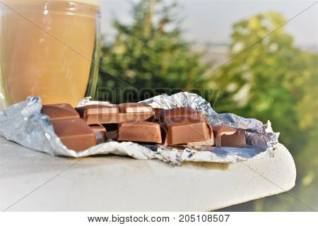 chocolate in foil on marble. pieces milk and dark chocolate. its  delicious. sweet dessert. milk coffee