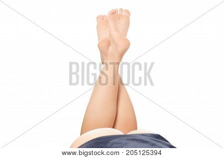 Female legs seen ass and on a white background isolated